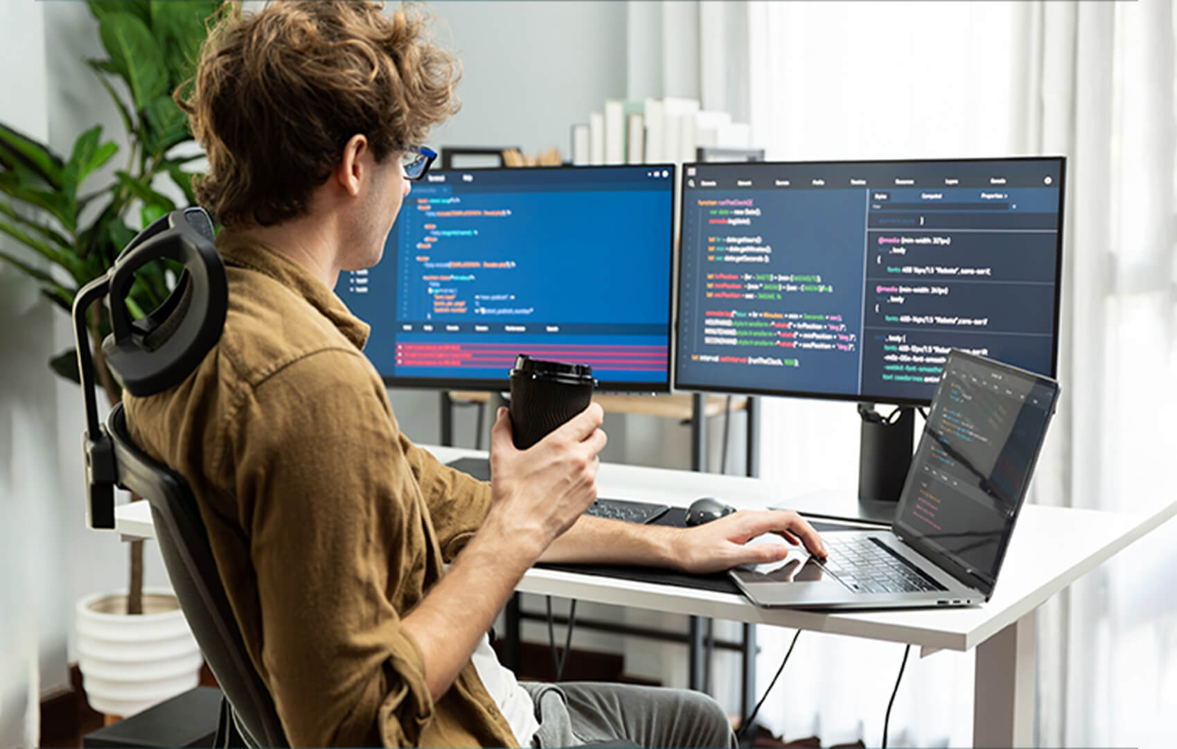 DotClick: Developer working on multiple monitors with code, indicating high-performance Node.js development.