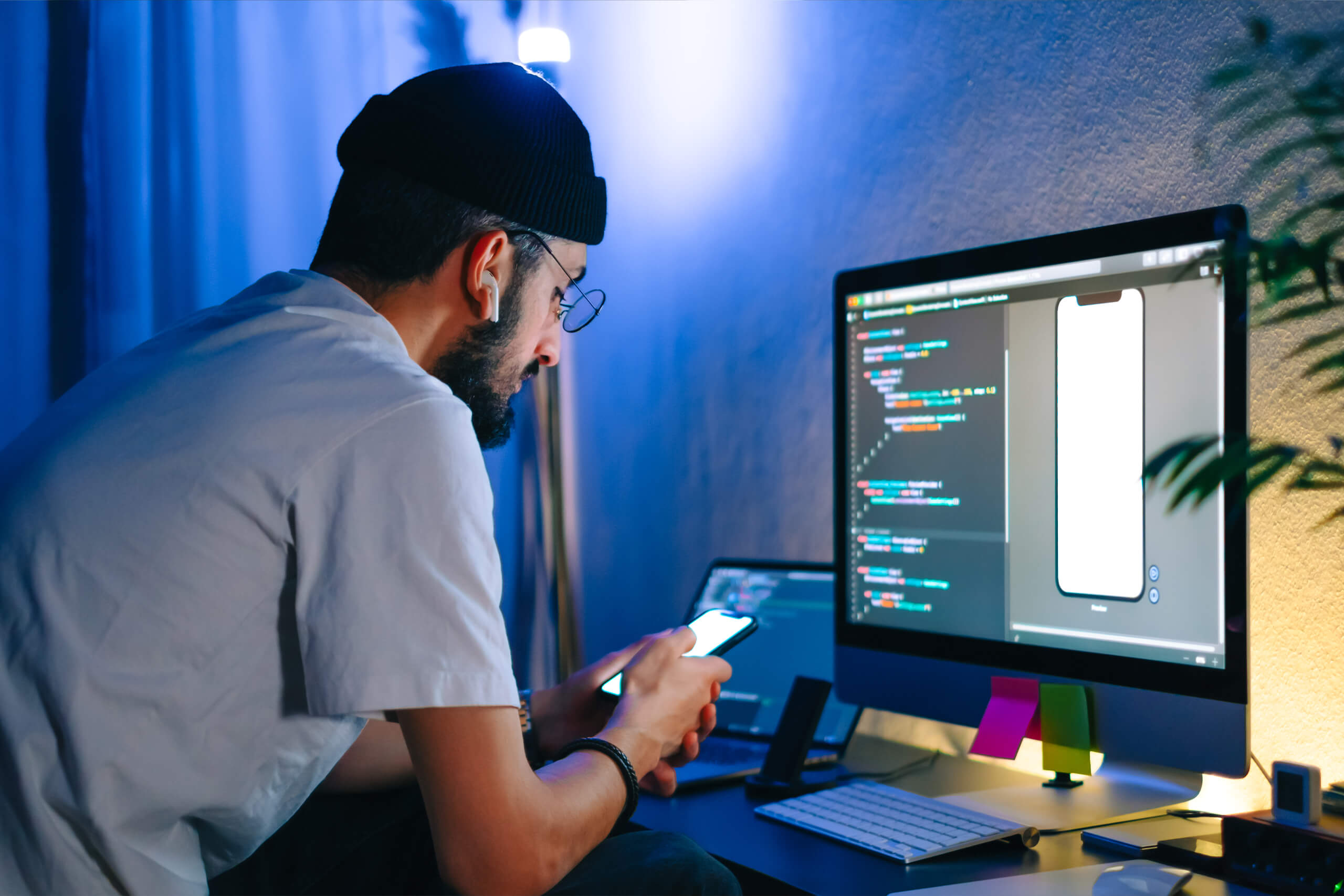 DotClick: A designer working on a desktop computer with design elements visible, focusing on UI/UX principles.